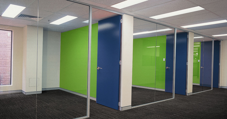 Bright modern office hallway with glass partition walls